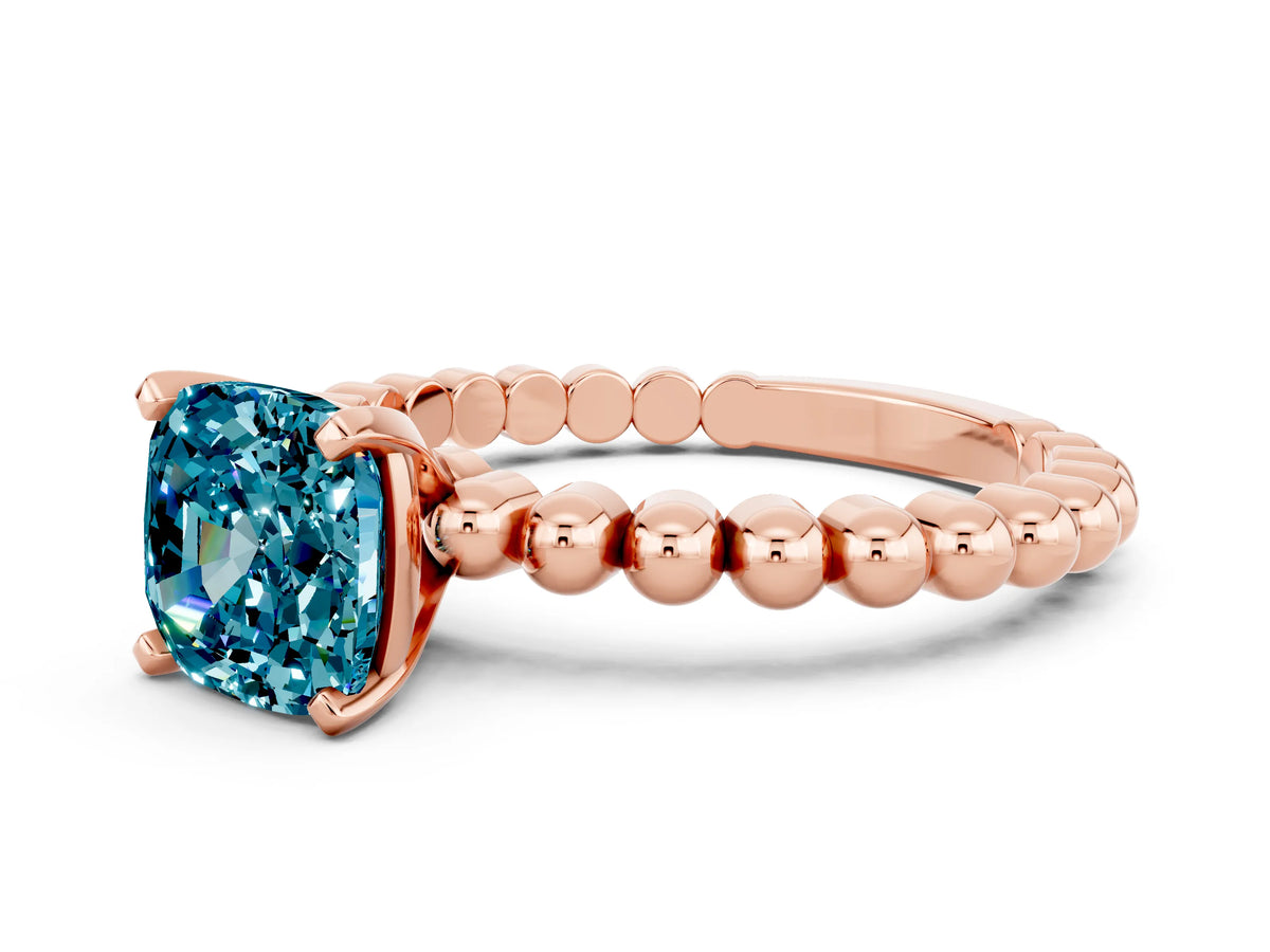 Cushion Cut Blue Topaz Solitaire Ring in Rose gold with Textured Beaded Band and Prong Setting