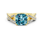 Cushion Cut Blue Topaz Solitaire Ring in Yellow gold with Interwoven Pavé Band and Prong Setting