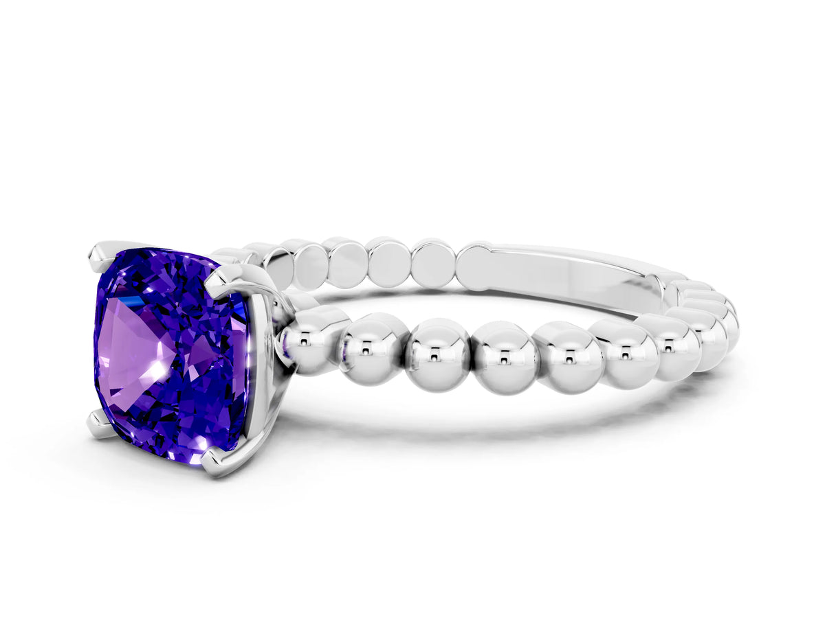 Cushion Cut Tanzanite Solitaire Ring in Platinum with Textured Beaded Band and Prong Setting
