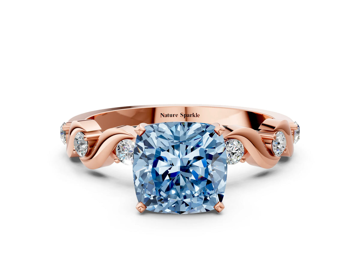 Fancy Blue Cushion Cut Diamond Solitaire Ring in Rose gold with Twisted Ribbon Band and Round Accents