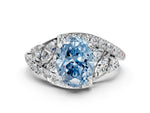 Fancy Blue Oval Cut Diamond Halo Ring in White gold with Marquise and Pavé Band in Prong Setting