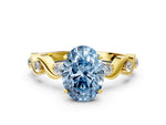 Fancy Blue Oval Cut Diamond Solitaire Ring in Yellow gold with Twisted Ribbon Band and Round Accents