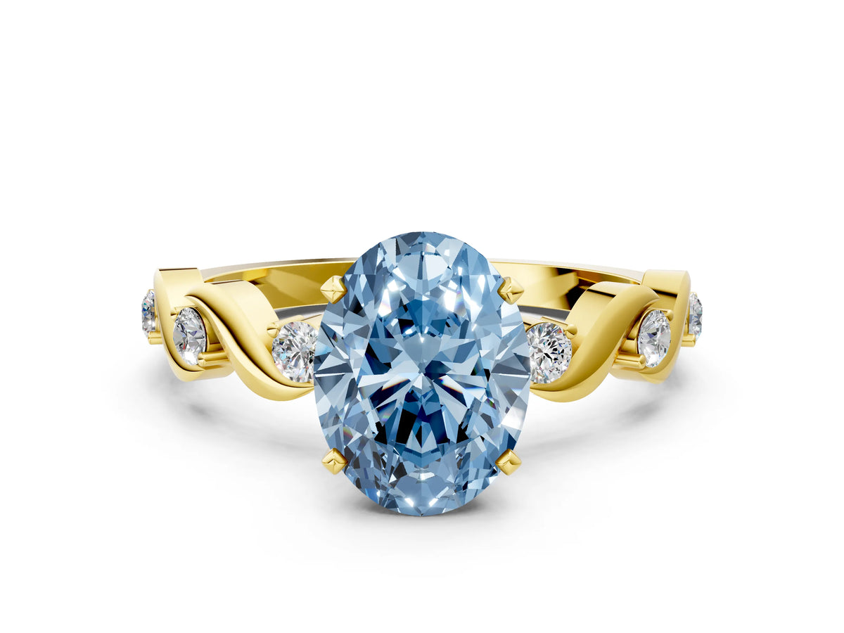 Fancy Blue Oval Cut Diamond Solitaire Ring in Yellow gold with Twisted Ribbon Band and Round Accents