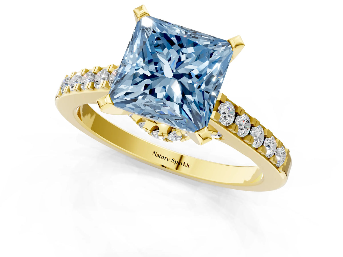Fancy Blue Princess Cut Diamond Solitaire Ring in Yellow gold with Crossover Gallery and Round Pavé Band_1