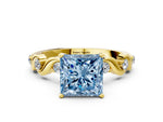 Fancy Blue Princess Cut Diamond Solitaire Ring in Yellow gold with Twisted Ribbon Band and Round Accents