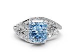 Fancy Blue Radiant Cut Diamond Halo Ring in White gold with Marquise and Pavé Band in Prong Setting