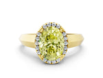 Fancy Yellow Oval Cut Diamond Halo Ring in Yellow gold with Cathedral Band and Prong Setting