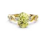 Fancy Yellow Oval Cut Diamond Solitaire Ring in Yellow gold with Twisted Ribbon Band and Round Accents