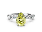 Fancy Yellow Pear Cut Diamond Solitaire Ring in Platinum with Twisted Ribbon Band and Round Accents