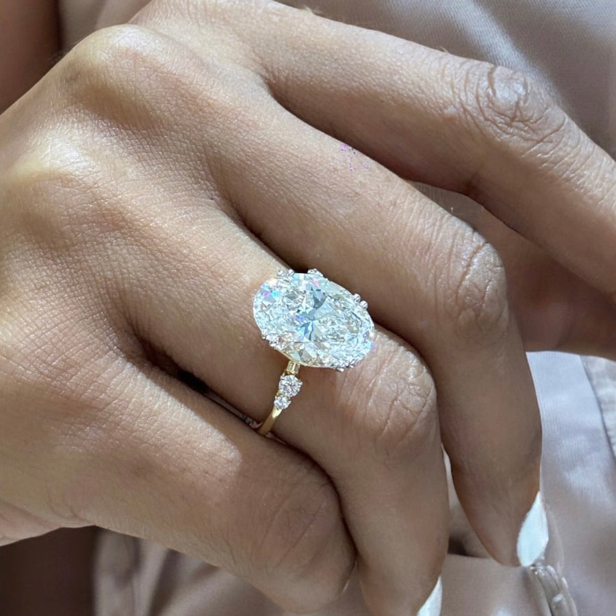 Yellow gold Oval Diamond Side Stone Engagement Ring with Round Accents