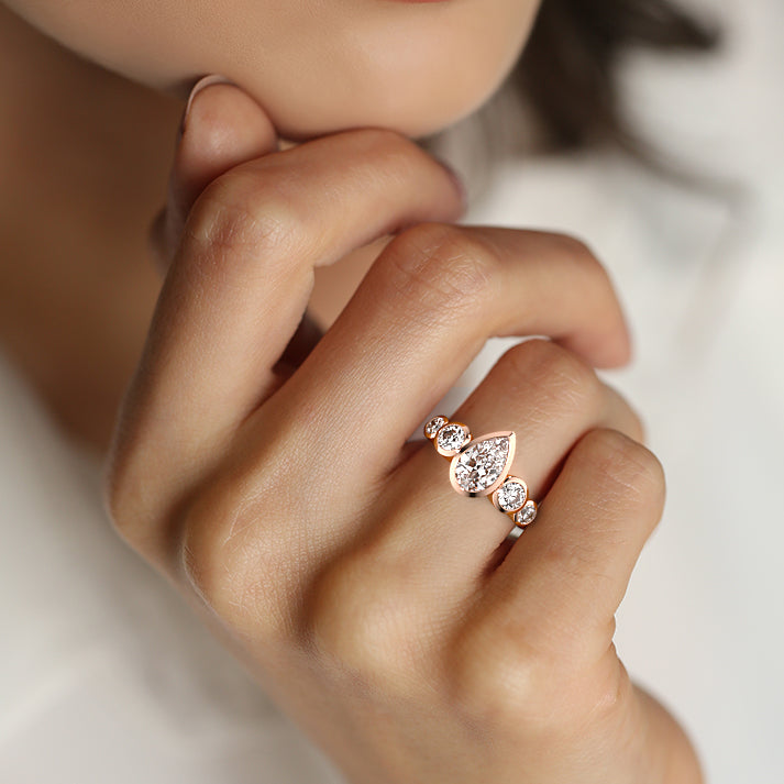 Rose gold Pear Diamond Ring with Bezel Setting and Round Side Accents
