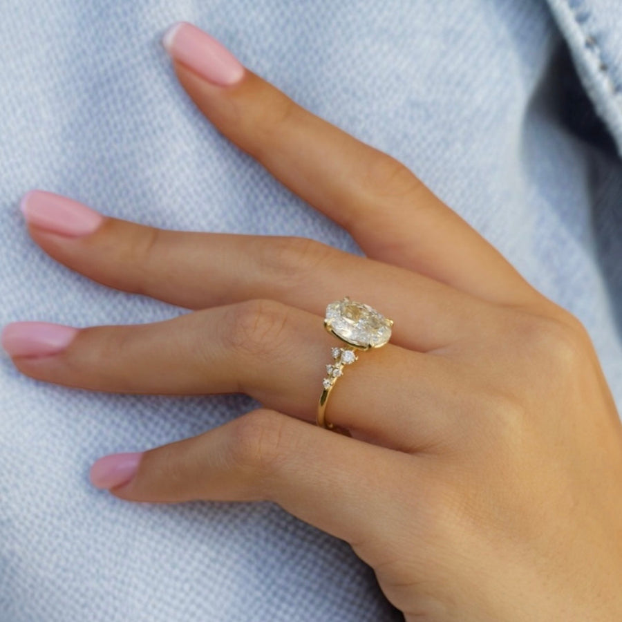 Yellow gold Oval Diamond Side Stone Engagement Ring with Clustered Round Accents