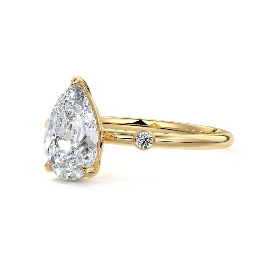 Yellow gold Pear Diamond Side Stone Ring with Round Accents