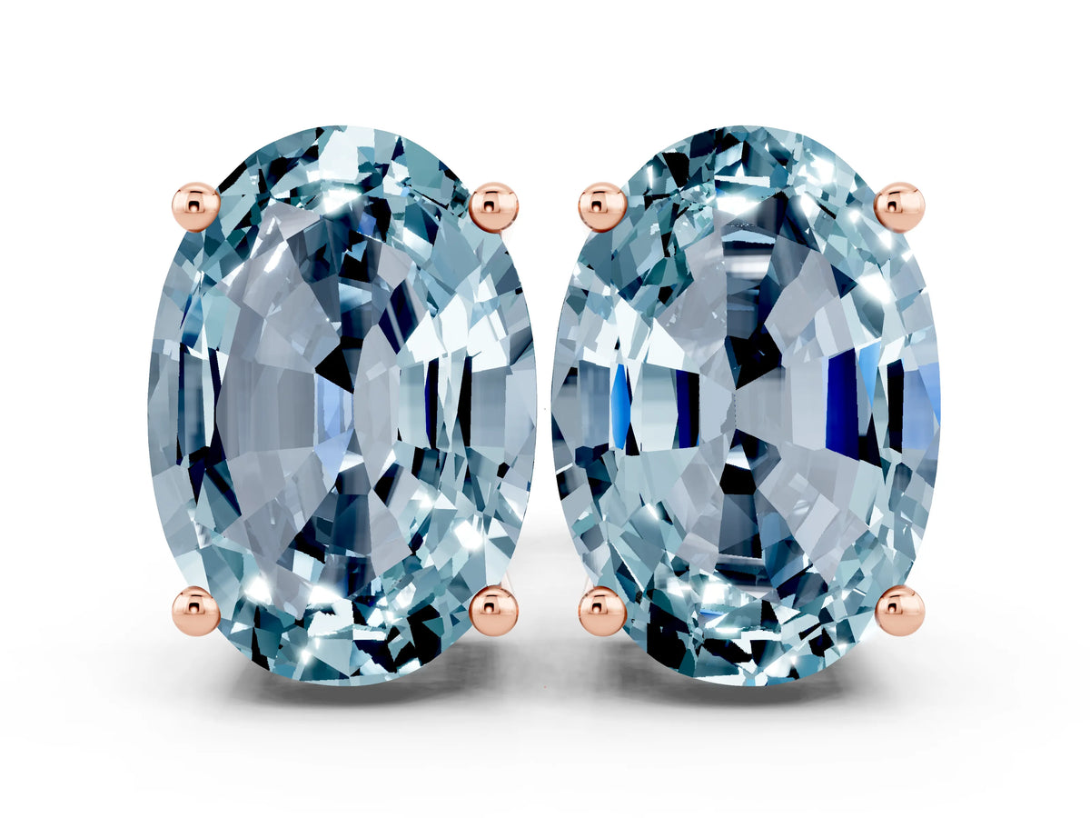Oval Cut Aquamarine Stud Earrings in Rose gold with Basket Setting