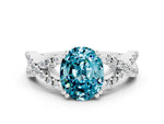 Oval Cut Blue Topaz Solitaire Ring in White gold with Interwoven Pavé Band and Prong Setting