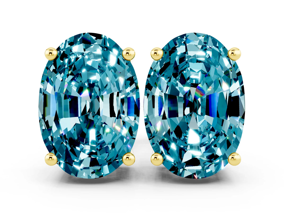 Oval Cut Blue Topaz Stud Earrings in Yellow gold with Basket Setting