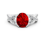 Oval Cut Ruby Solitaire Ring in White gold with Interwoven Pavé Band and Prong Setting