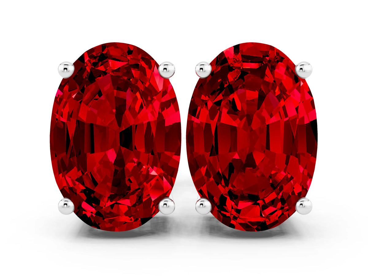 Oval Cut Ruby Stud Earrings in White gold with Basket Setting