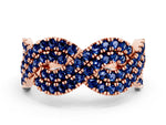 Pavé Round Blue Sapphire Infinity Twist Band in Rose gold with Shared Prong Setting