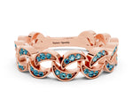 Pavé Round Blue Topaz Interlocking Eternity Band in Rose gold with Bezel Prong Setting