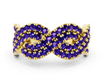 Pavé Round Tanzanite Infinity Twist Band in Yellow gold with Shared Prong Setting