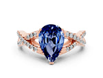 Pear Cut Blue Sapphire Solitaire Ring in Rose gold with Interwoven Pavé Band and Prong Setting