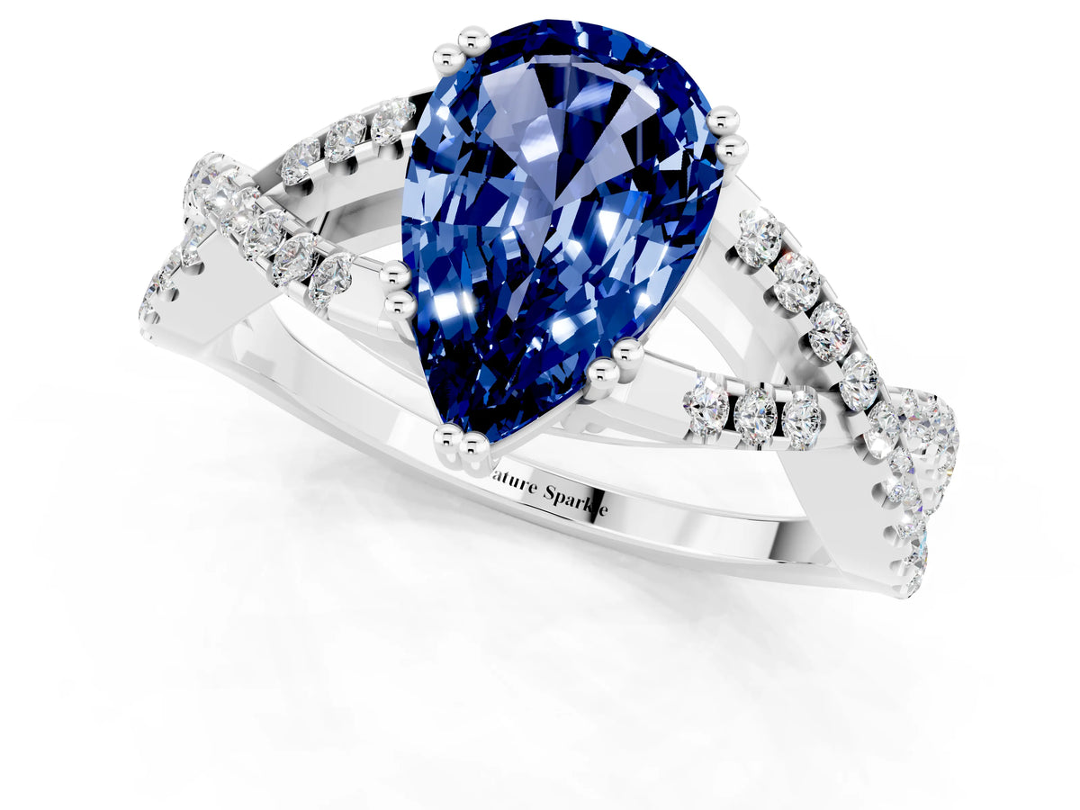Pear Cut Blue Sapphire Solitaire Ring in White gold with Interwoven Pavé Band and Prong Setting_1