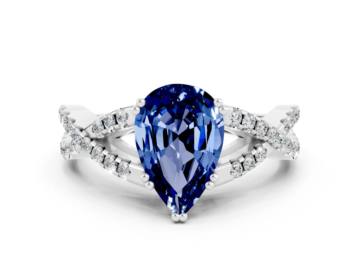 Pear Cut Blue Sapphire Solitaire Ring in White gold with Interwoven Pavé Band and Prong Setting