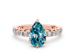 Pear Cut Blue Topaz Pavé Solitaire Ring in Rose gold with Round Pavé Band and Prong Setting