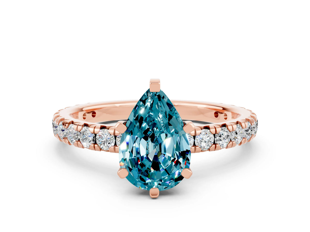 Pear Cut Blue Topaz Pavé Solitaire Ring in Rose gold with Round Pavé Band and Prong Setting