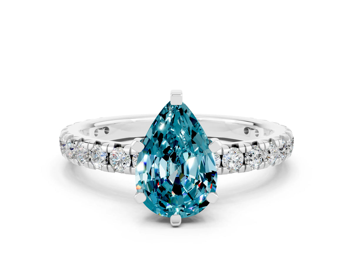 Pear Cut Blue Topaz Pavé Solitaire Ring in White gold with Round Pavé Band and Prong Setting