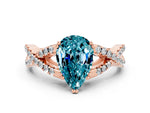 Pear Cut Blue Topaz Solitaire Ring in Rose gold with Interwoven Pavé Band and Prong Setting