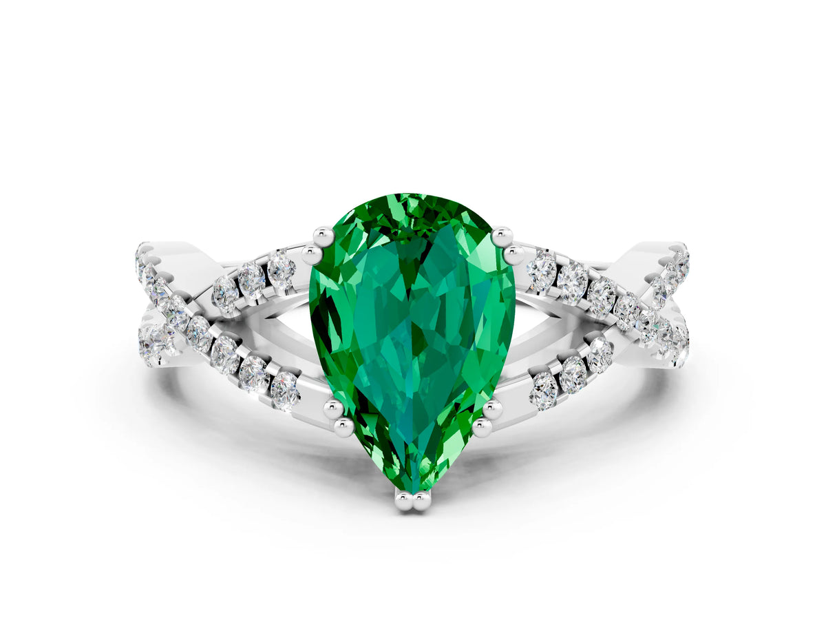 Pear Cut Emerald Solitaire Ring in White gold with Interwoven Pavé Band and Prong Setting
