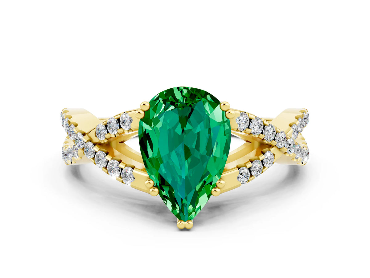 Pear Cut Emerald Solitaire Ring in Yellow gold with Interwoven Pavé Band and Prong Setting