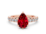 Pear Cut Ruby Pavé Solitaire Ring in Rose gold with Round Pavé Band and Prong Setting