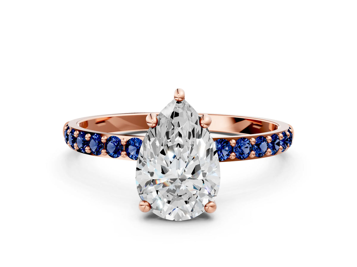Rose gold Pear Cut Diamond Solitaire Ring with Round Blue Sapphire Pavé Band and Prong Setting
