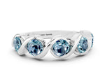 Round Aquamarine Wave Band in White gold with Channel Setting and Shared Prongs