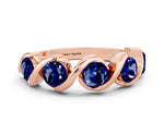 Round Blue Sapphire Wave Band in Rose gold with Channel Setting and Shared Prongs