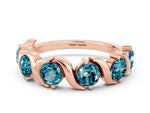 Round Blue Topaz Half Eternity Band in Rose gold with Wave Prong Setting