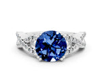 Round Cut Blue Sapphire Solitaire Ring in White gold with Interwoven Pavé Band and Prong Setting