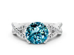 Round Cut Blue Topaz Solitaire Ring in White gold with Interwoven Pavé Band and Prong Setting