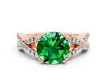 Round Cut Emerald Solitaire Ring in Rose gold with Interwoven Pavé Band and Prong Setting