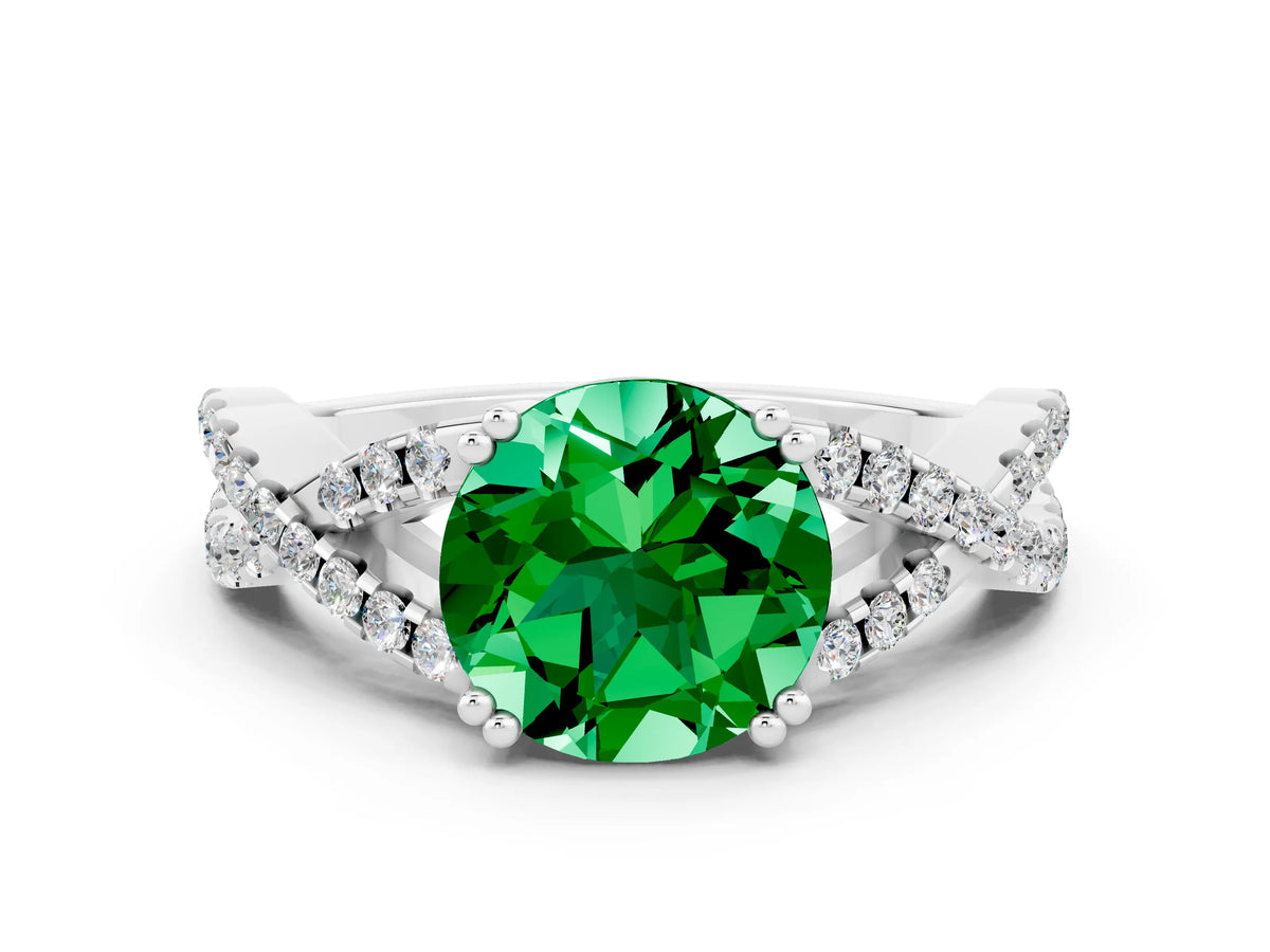 Round Cut Emerald Solitaire Ring in White gold with Interwoven Pavé Band and Prong Setting
