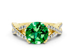 Round Cut Emerald Solitaire Ring in Yellow gold with Interwoven Pavé Band and Prong Setting