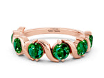 Round Emerald Half Eternity Band in Rose gold with Wave Prong Setting