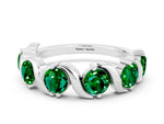 Round Emerald Half Eternity Band in White gold with Wave Prong Setting