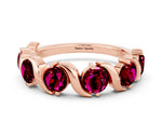 Round Garnet Half Eternity Band in Rose gold with Wave Prong Setting