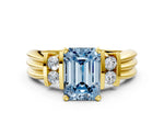 Three-Stone Fancy Blue Emerald Cut Diamond Channel Set Ring in Yellow gold with Bar Prongs