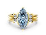 Three-Stone Fancy Blue Marquise Cut Diamond Channel Set Ring in Yellow gold with Bar Prongs