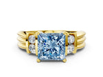 Three-Stone Fancy Blue Princess Cut Diamond Channel Set Ring in Yellow gold with Bar Prongs